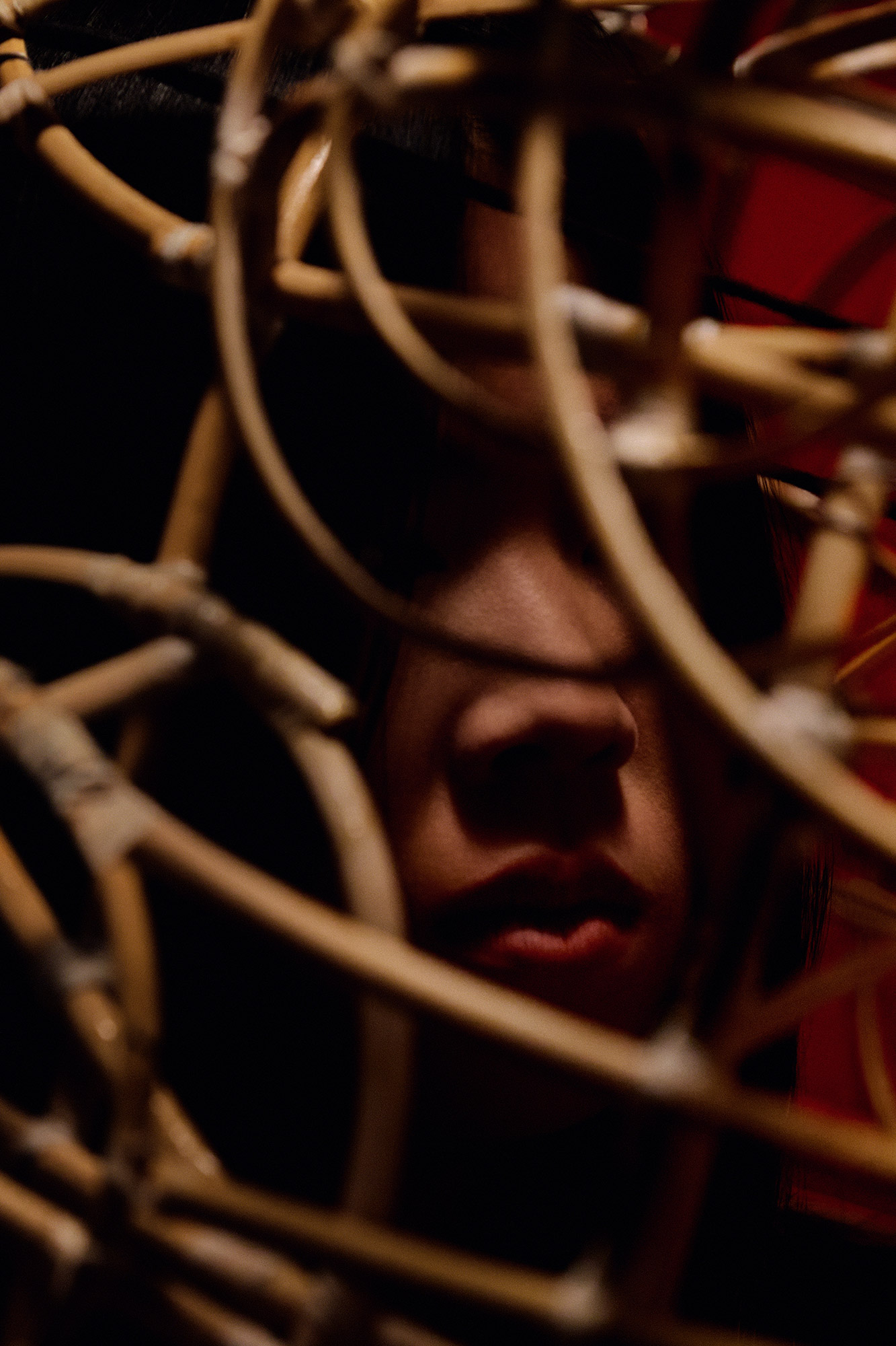 A close up image of a person's face whilst they examine a model