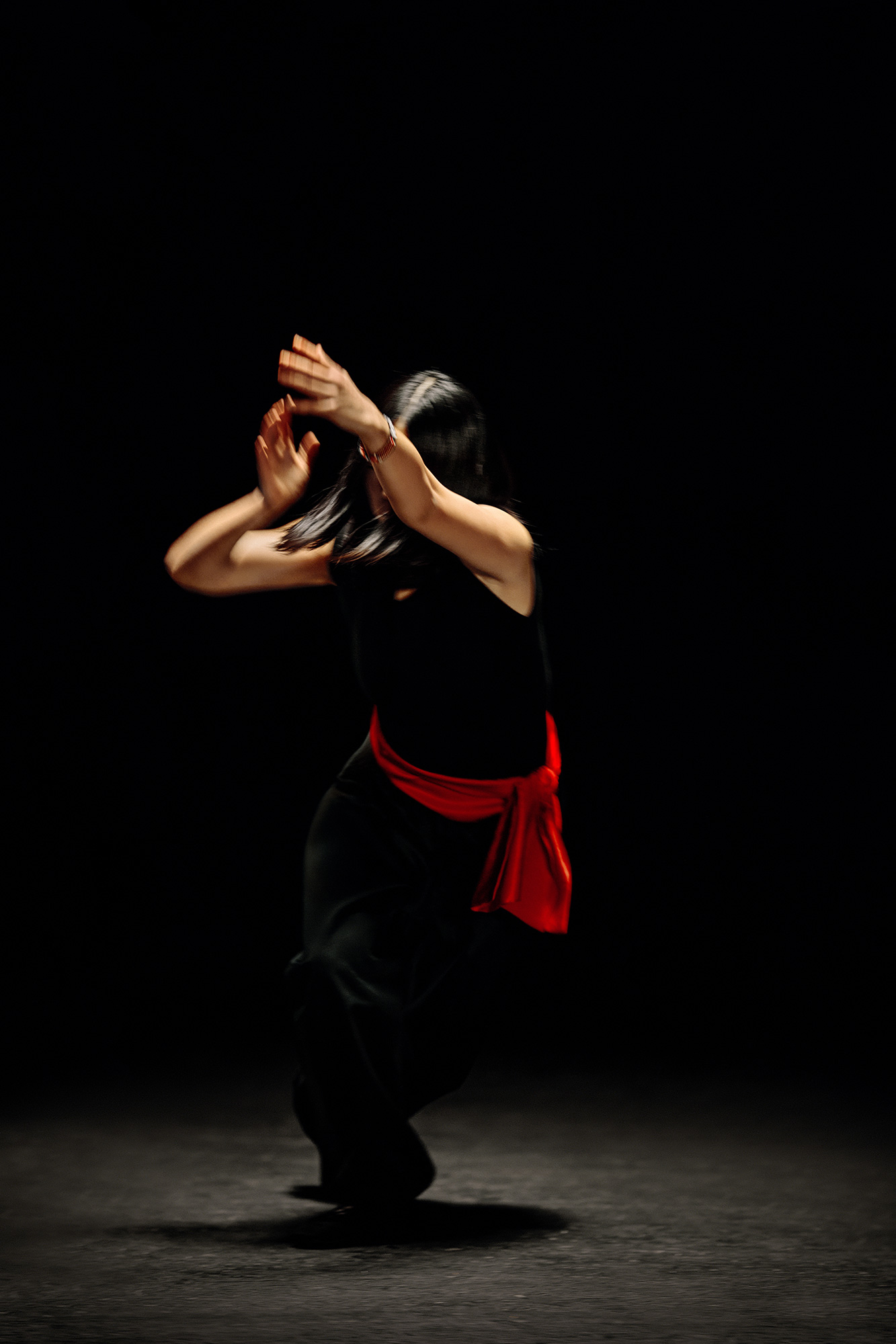 A woman dancing in a dark room