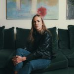 Carmen sitting on a green sofa