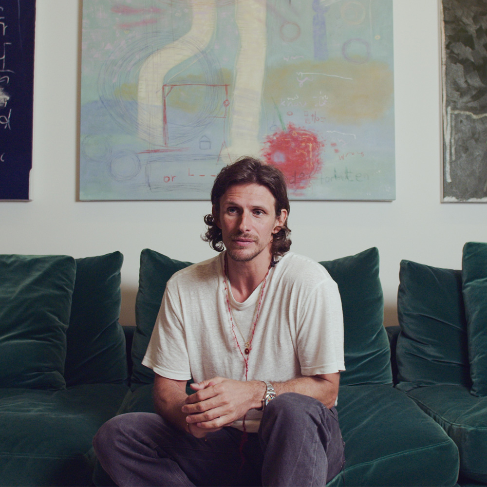 Jake sitting on a green sofa