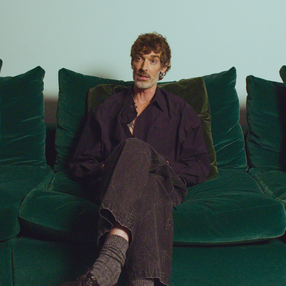 Richard sitting on a green sofa